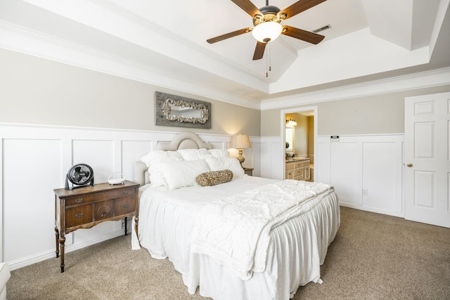 bedroom featuring a raised ceiling, light colored carpet, crown molding, and visible vents