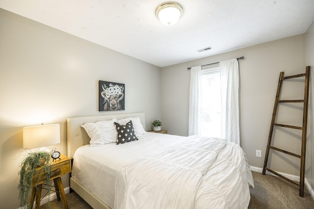 carpeted bedroom with visible vents and baseboards