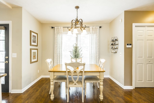 dining area with baseboards, a chandelier, and wood finished floors