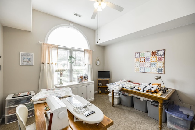 office featuring visible vents, ceiling fan, and light carpet