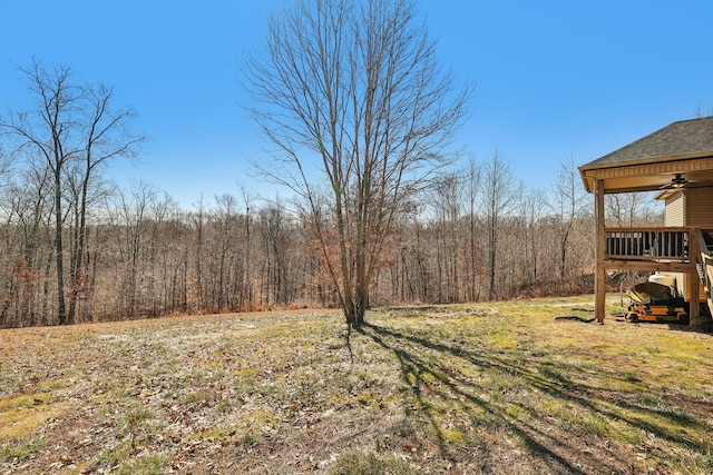 view of yard featuring a forest view