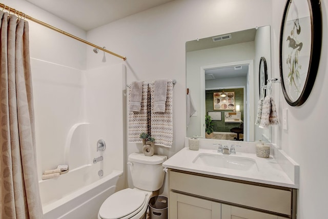 bathroom featuring shower / bath combination with curtain, visible vents, vanity, and toilet