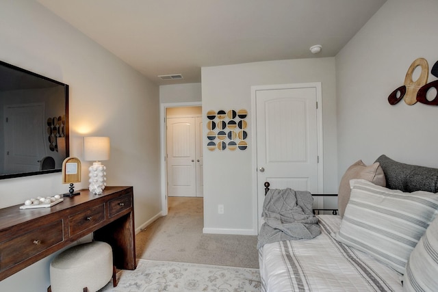 interior space with light colored carpet, visible vents, and baseboards