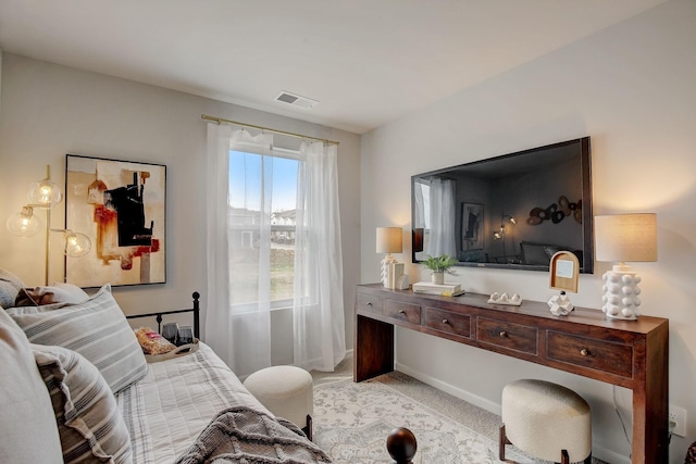 bedroom featuring light colored carpet, visible vents, and baseboards