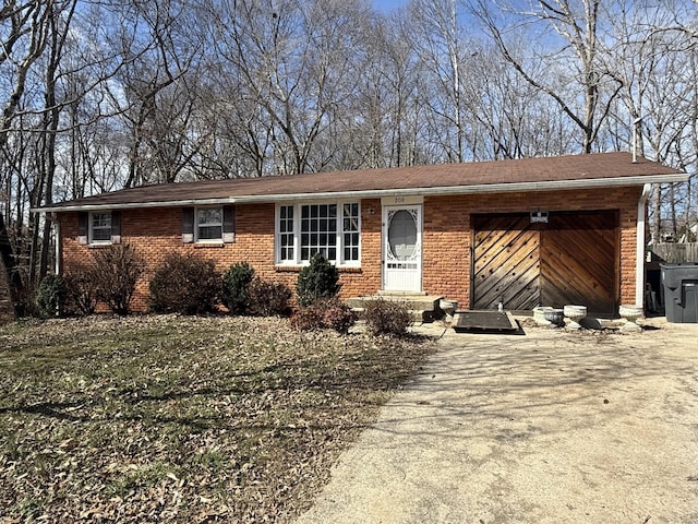 ranch-style home with a garage, driveway, and brick siding