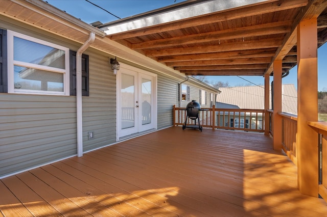 wooden terrace with french doors and a grill