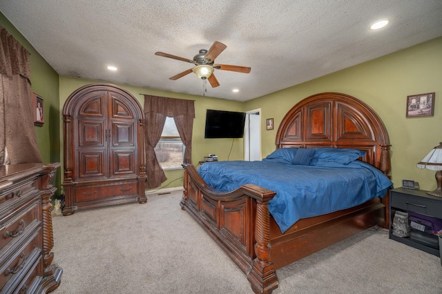 bedroom with recessed lighting, light colored carpet, ceiling fan, and a textured ceiling