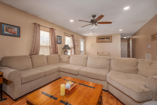 living room with visible vents, ceiling fan, a textured ceiling, light wood-type flooring, and recessed lighting