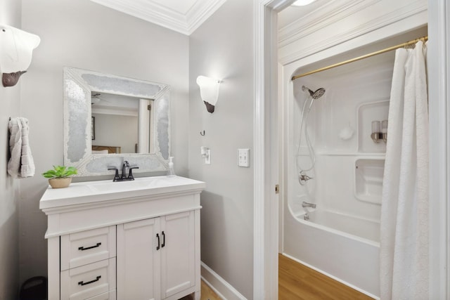 bathroom with shower / bath combo, baseboards, ornamental molding, wood finished floors, and vanity