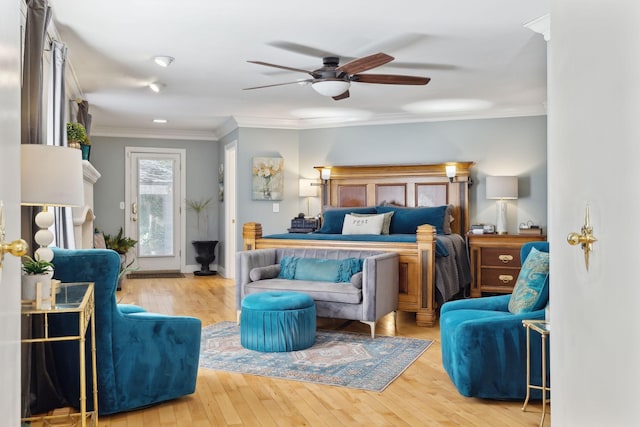 bedroom with hardwood / wood-style flooring, baseboards, ornamental molding, and a ceiling fan