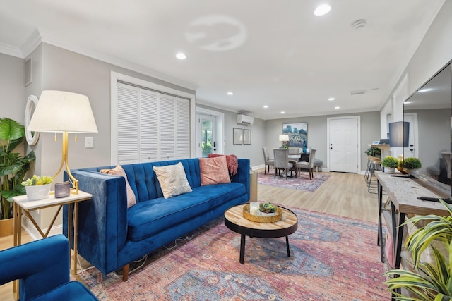 living area with baseboards, ornamental molding, light wood-style flooring, and recessed lighting