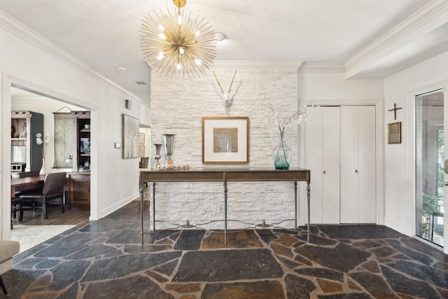 interior space featuring crown molding, stone finish flooring, baseboards, and a notable chandelier