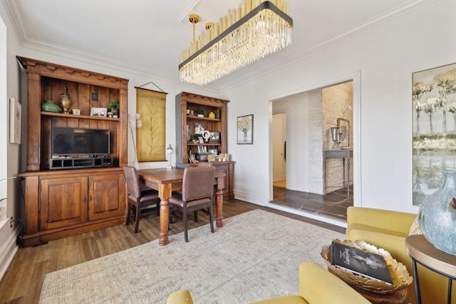 dining area with crown molding and wood finished floors