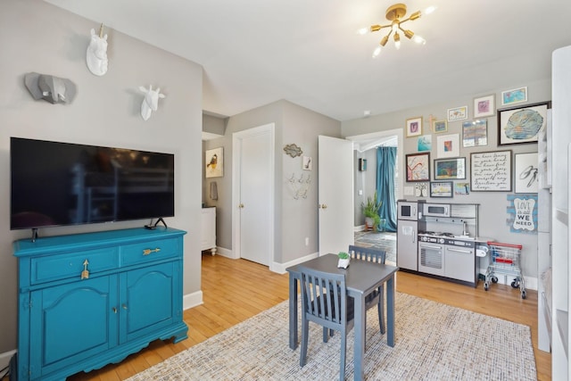 dining room with baseboards and light wood finished floors