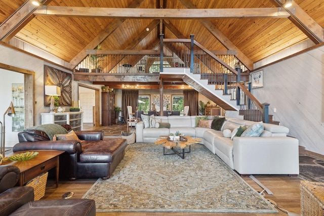 living area featuring wood ceiling, wood finished floors, vaulted ceiling with beams, and stairs