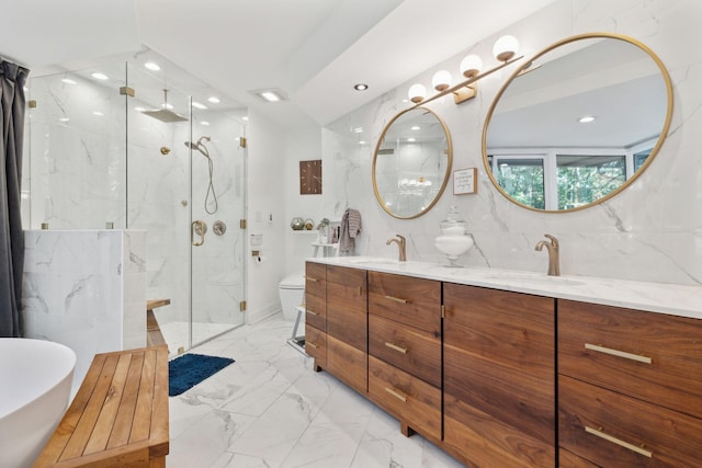 full bathroom featuring marble finish floor, a freestanding bath, a marble finish shower, and a sink