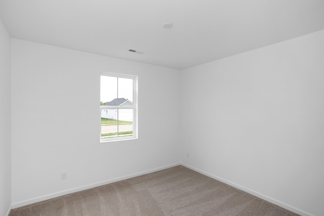 carpeted spare room with baseboards