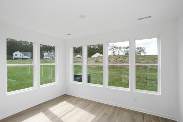 unfurnished sunroom featuring visible vents