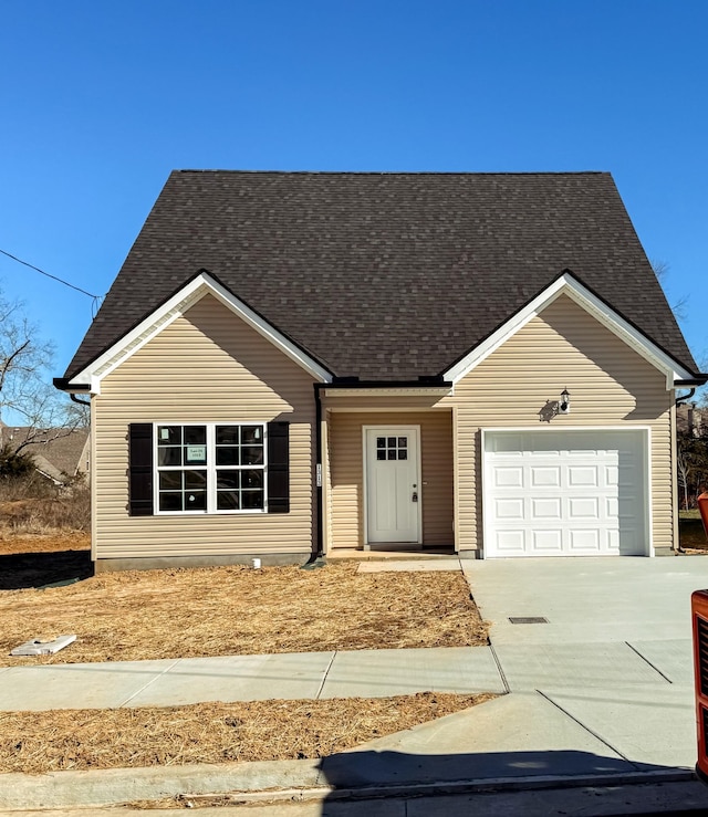 view of front of home with a shingled roof, driveway, and an attached garage