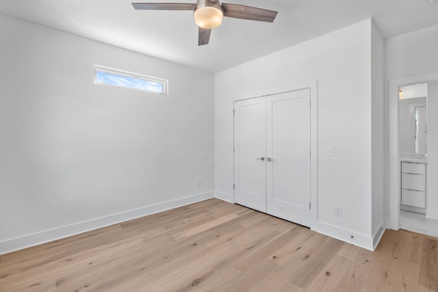 unfurnished bedroom with a closet, light wood-type flooring, a ceiling fan, and baseboards