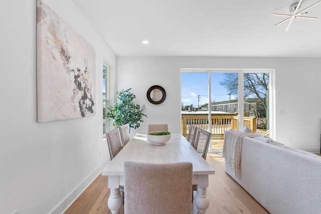 dining space with recessed lighting, baseboards, and light wood finished floors