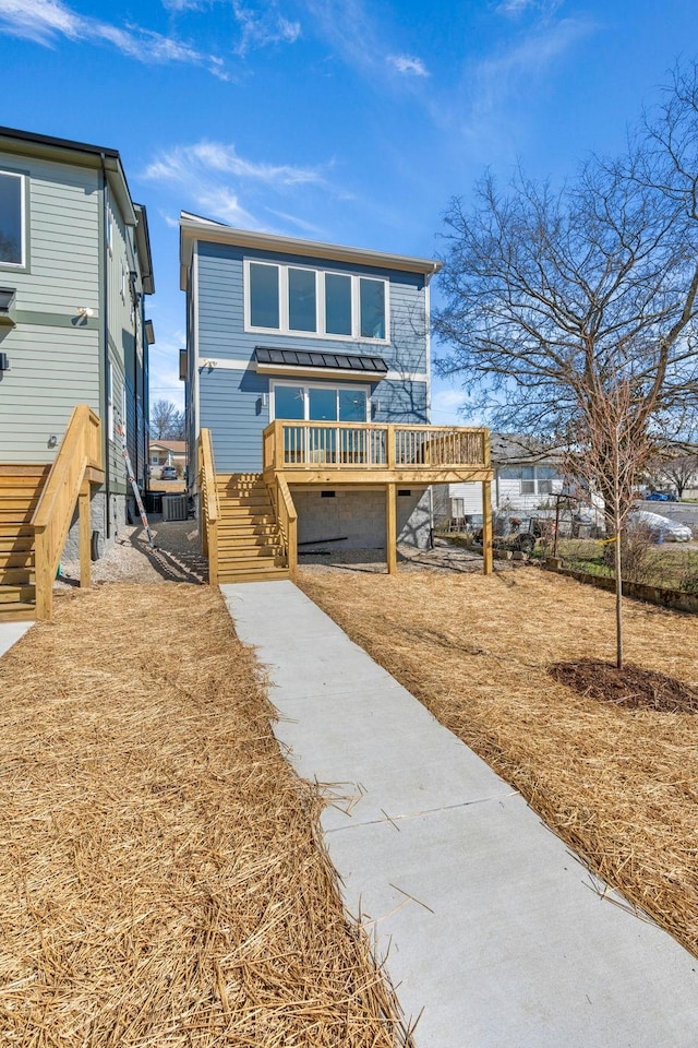 view of front of house featuring stairs and a wooden deck