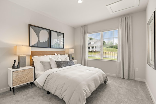 bedroom featuring attic access, carpet, and baseboards