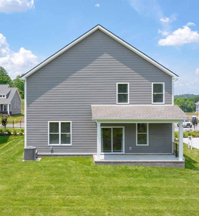 back of house with a lawn and central AC unit