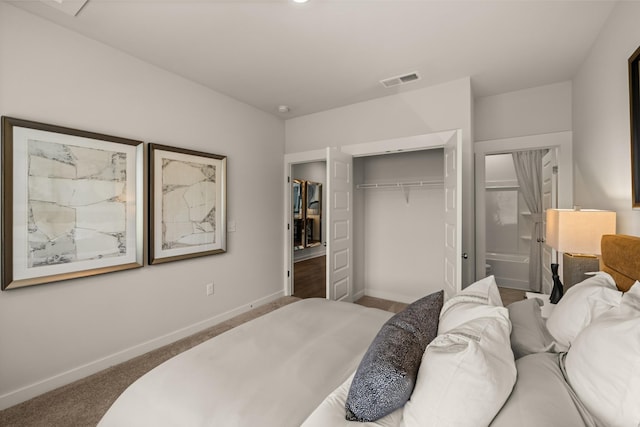 carpeted bedroom with a closet, visible vents, and baseboards