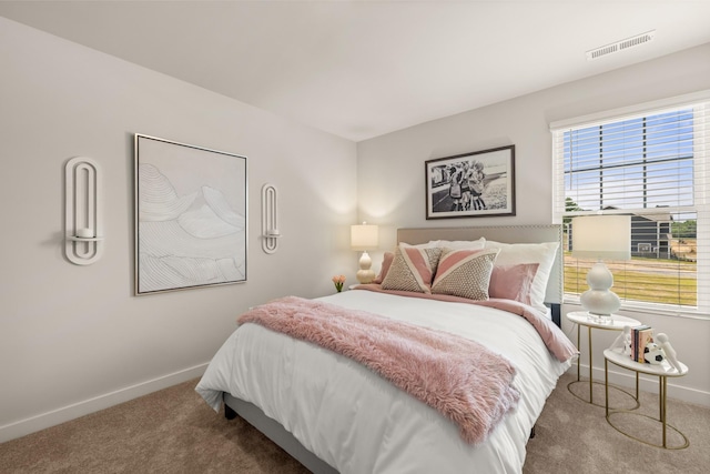 carpeted bedroom with baseboards and visible vents