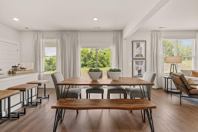 dining room with a healthy amount of sunlight, wood finished floors, and recessed lighting