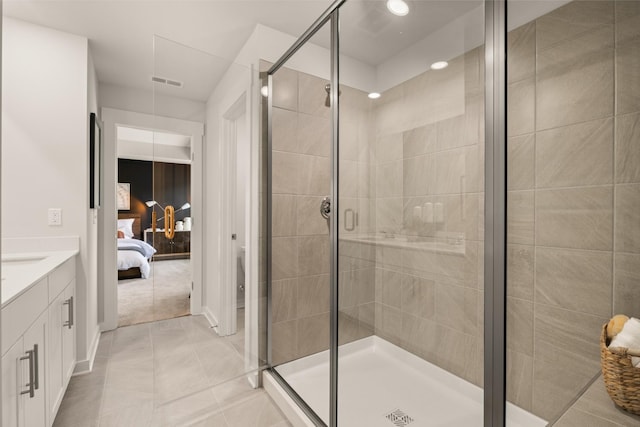 full bath with a stall shower, visible vents, connected bathroom, and vanity