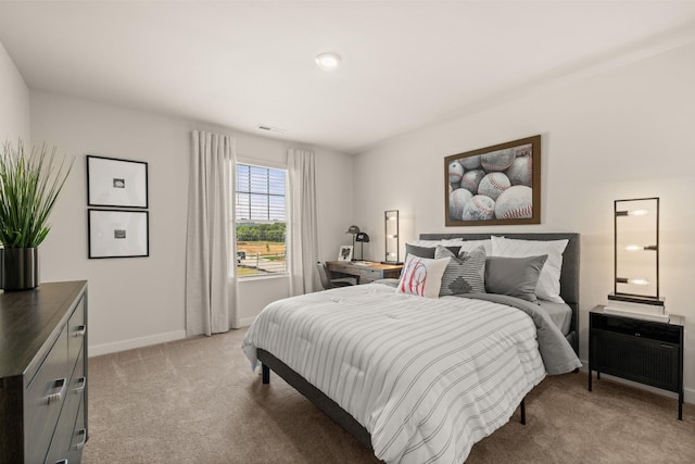 bedroom featuring light carpet, visible vents, and baseboards