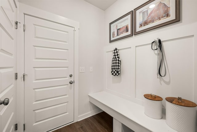 mudroom featuring dark wood-type flooring and baseboards