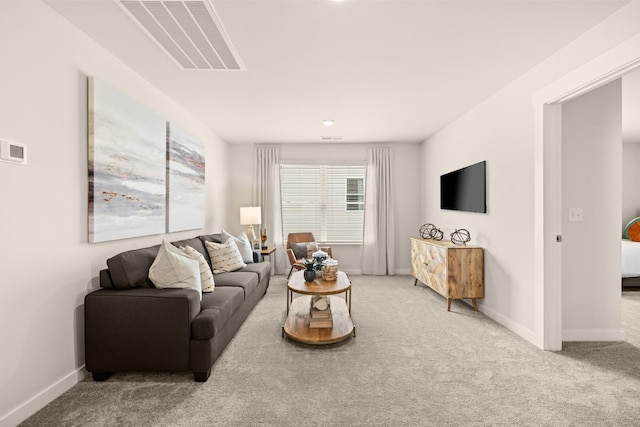 living area with baseboards, visible vents, and carpet flooring