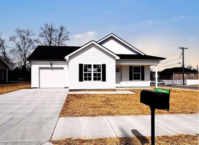 view of front of home featuring a garage, a porch, and concrete driveway