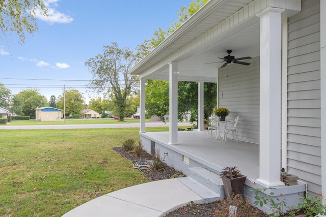 view of yard featuring a porch and a ceiling fan