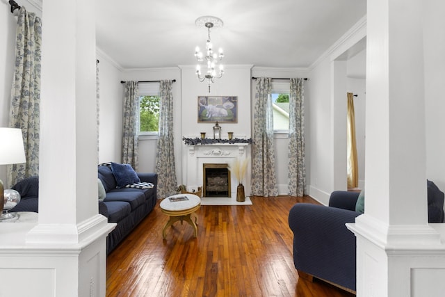 living room featuring ornamental molding, plenty of natural light, a fireplace with flush hearth, and hardwood / wood-style floors