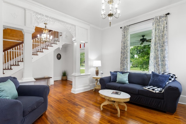 living room featuring ornamental molding, hardwood / wood-style flooring, decorative columns, and a healthy amount of sunlight