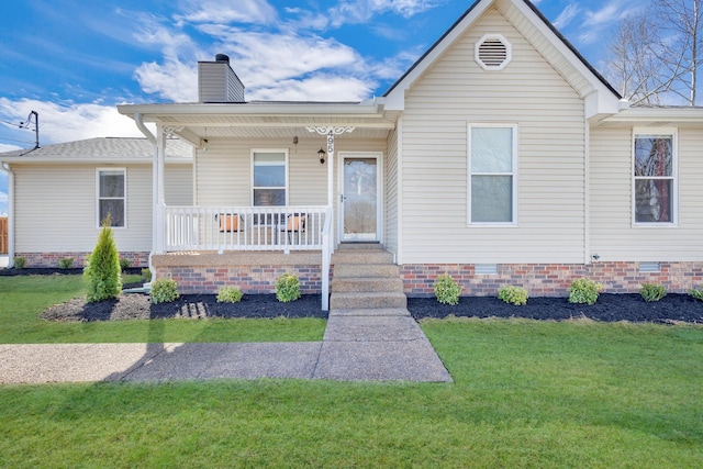 ranch-style home with a porch, crawl space, a chimney, and a front yard