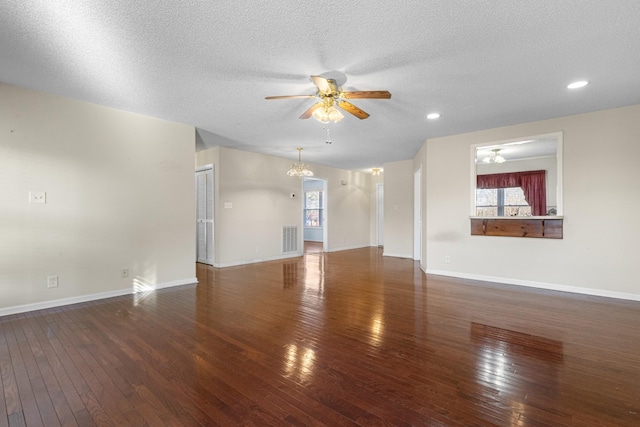 unfurnished living room with baseboards, visible vents, and hardwood / wood-style floors