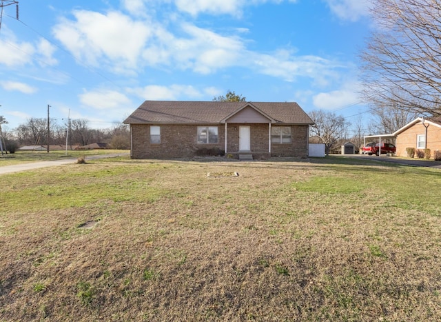 view of front of house with a front yard and brick siding