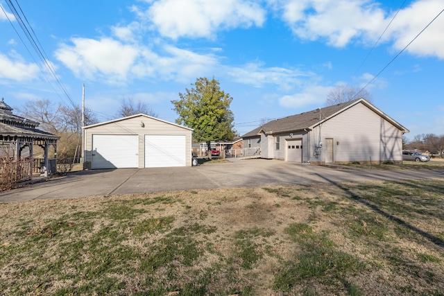 detached garage featuring fence