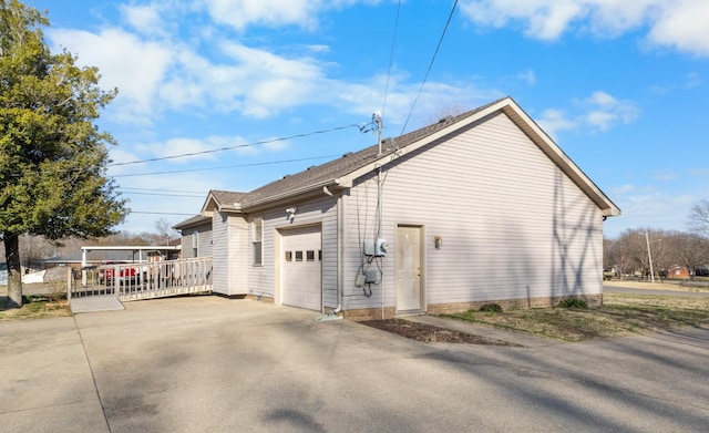 view of side of property with a garage and driveway