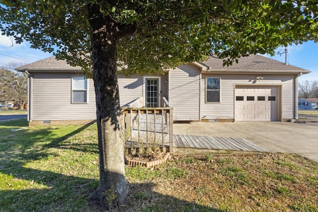 ranch-style home with a shingled roof, concrete driveway, an attached garage, crawl space, and a front lawn