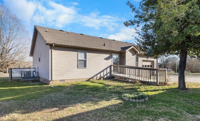 back of property with a deck, a yard, crawl space, and central AC