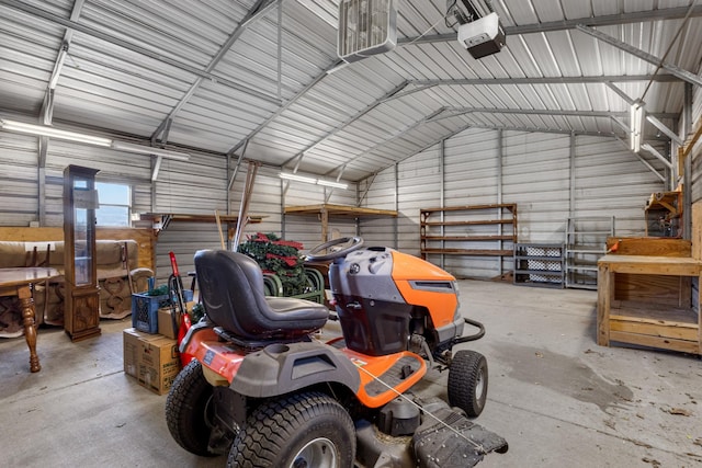 garage featuring metal wall and a garage door opener