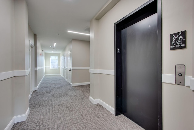 corridor featuring carpet, visible vents, and baseboards