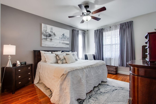 bedroom with ceiling fan and dark wood finished floors