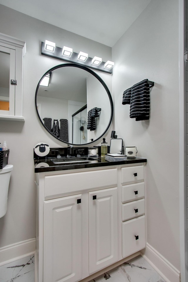 bathroom featuring marble finish floor, baseboards, and vanity